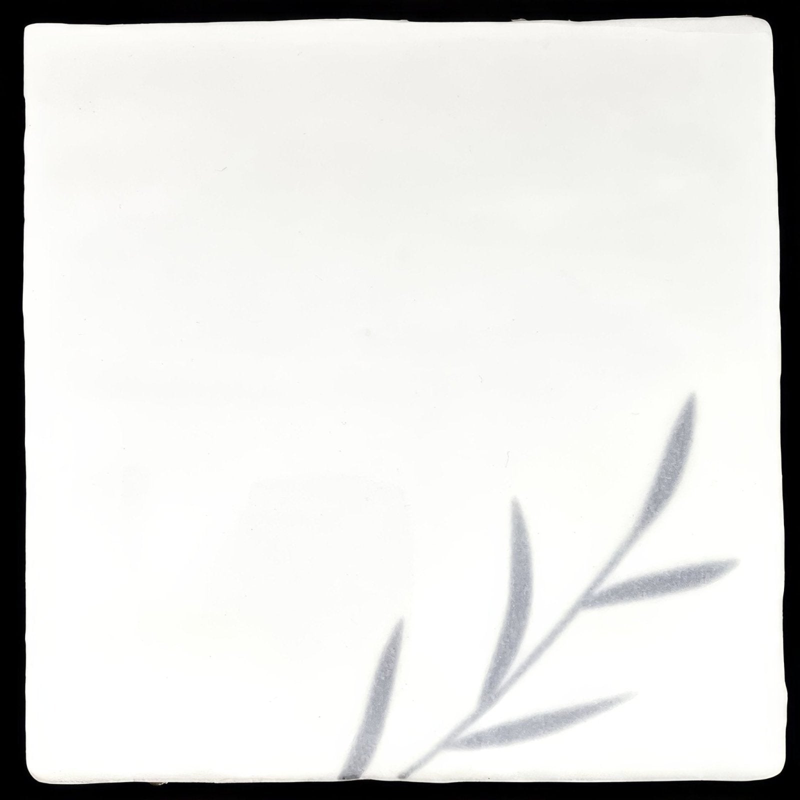 White ceramic tile jardin marsh 1 with a subtle gray leaf design in the corner