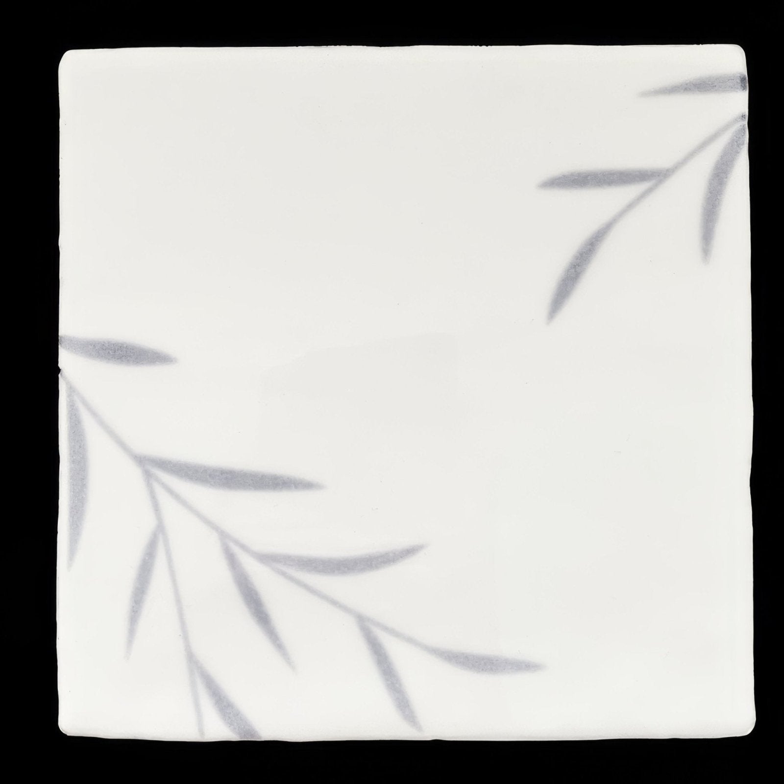 White ceramic tile jardin marsh 2 with subtle gray leafy branch patterns ideal for indoor wall decor