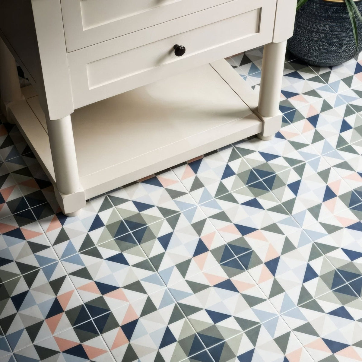 Kaleidoscope porcelain skipper floor tiles with geometric pattern in navy gray blush pink and white colors
