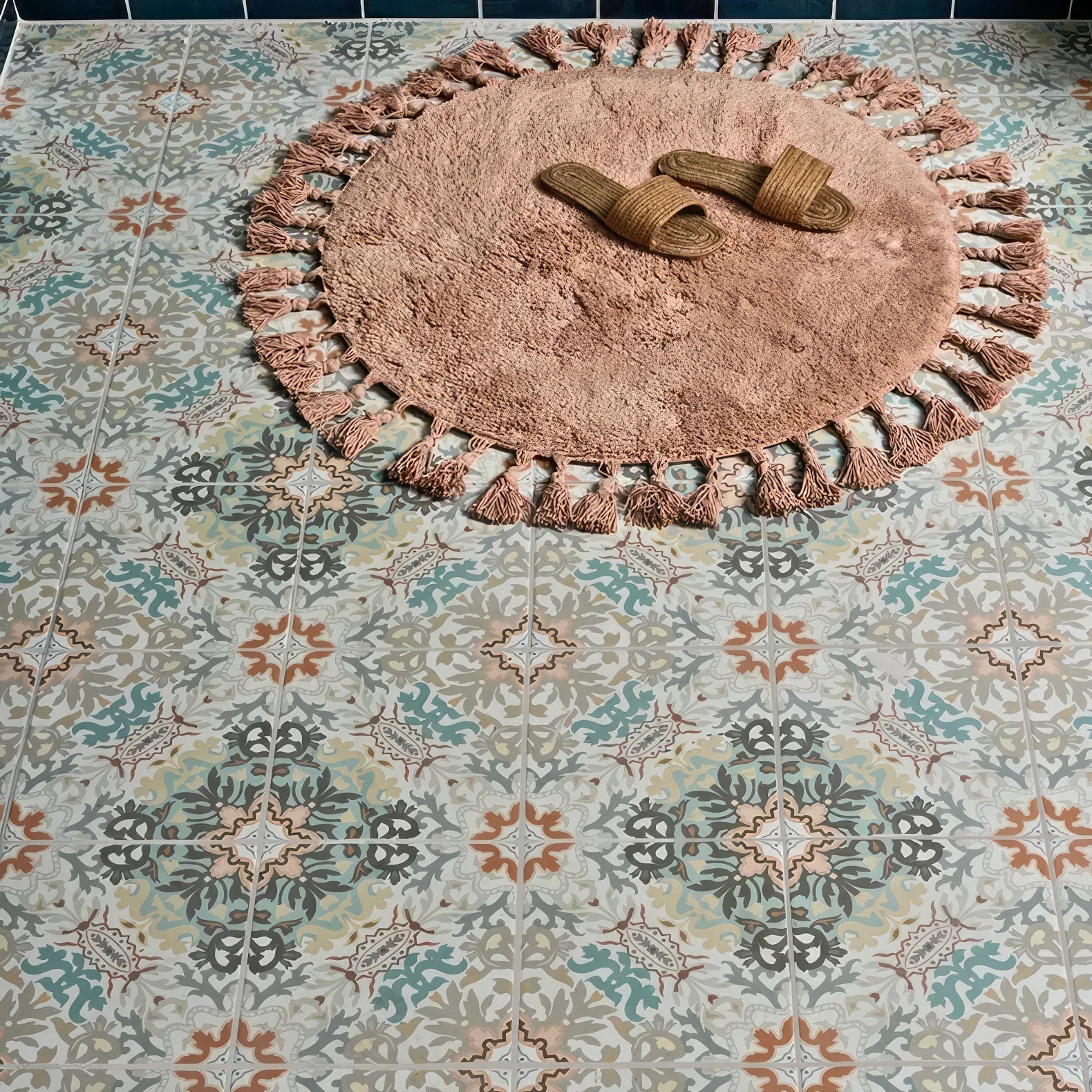A soft dusty rose-colored round tasselled fringe rug with textured surface from kashmir porcelain earthern collection