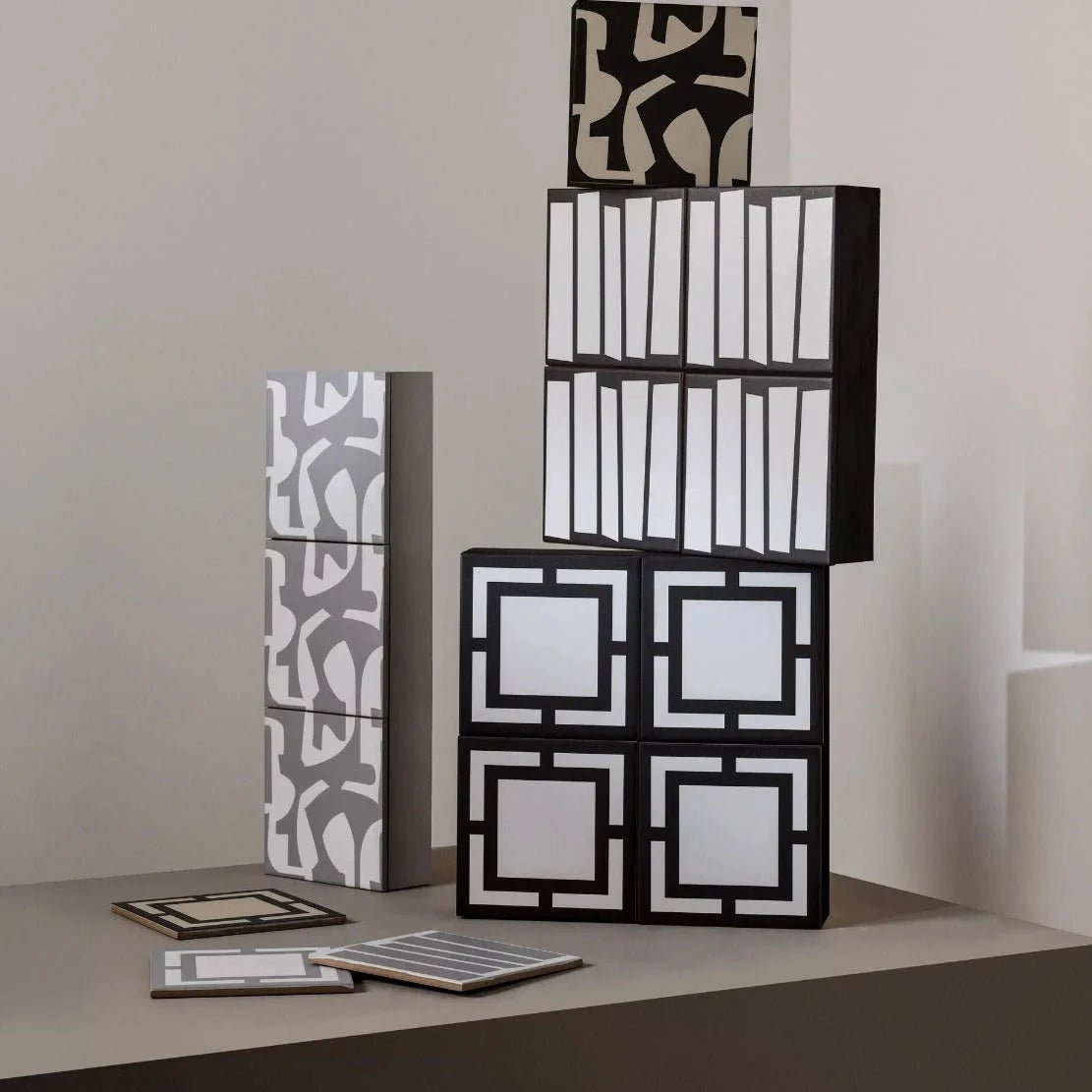 Black and white geometric patterned modular storage cubes with a modern minimalist design from kelly hoppen signature gray and white