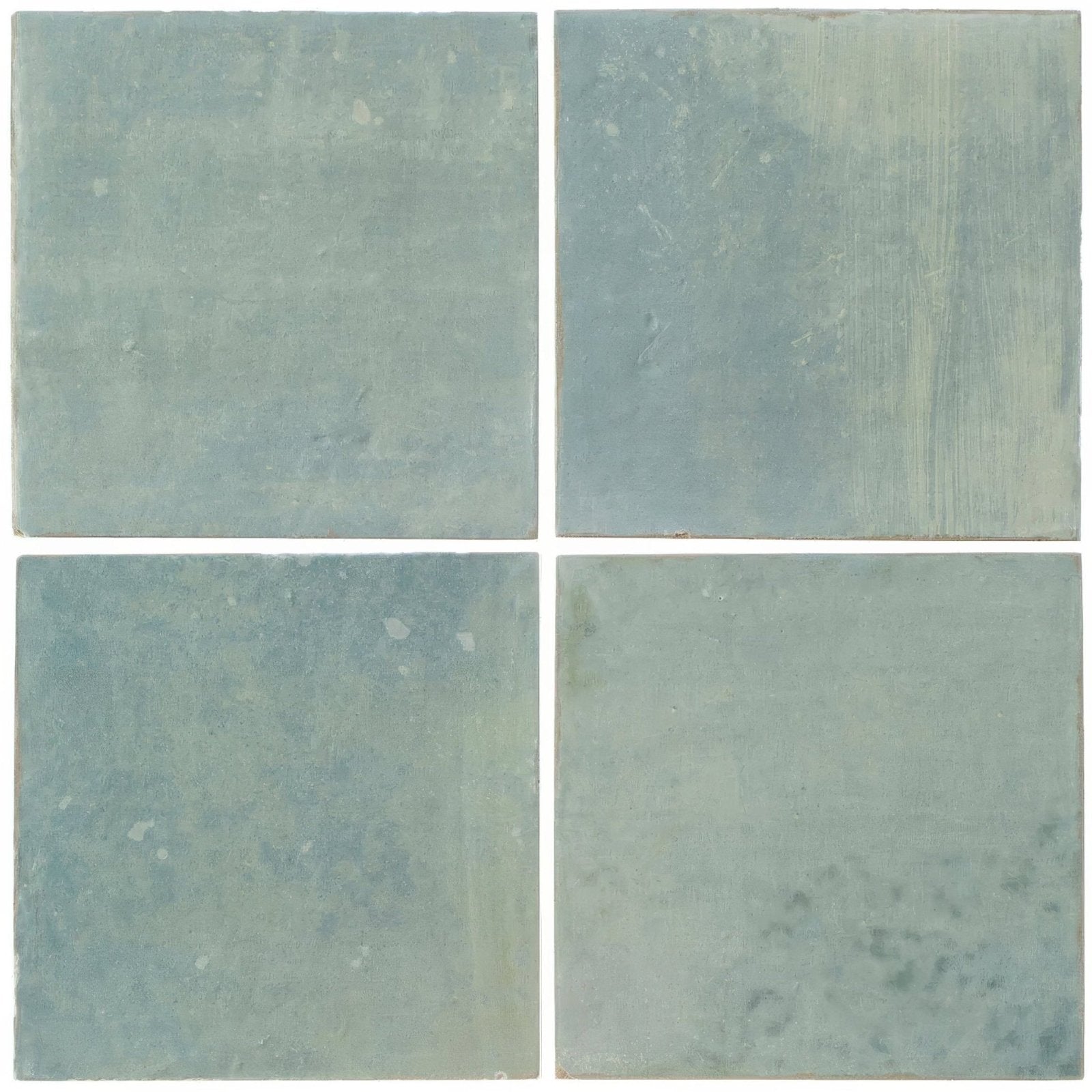 Four kelmscott green ceramic tiles with muted teal blue glaze and natural variations in tone and texture