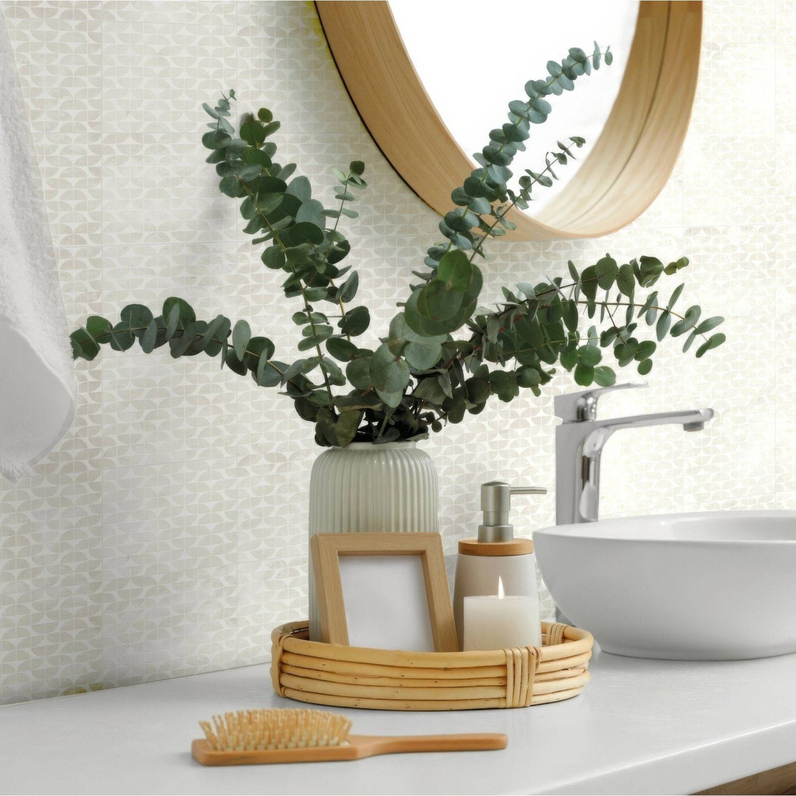 A tall ribbed ceramic vase in soft sage green holds eucalyptus branches alongside Kelmscott Lytes white tile