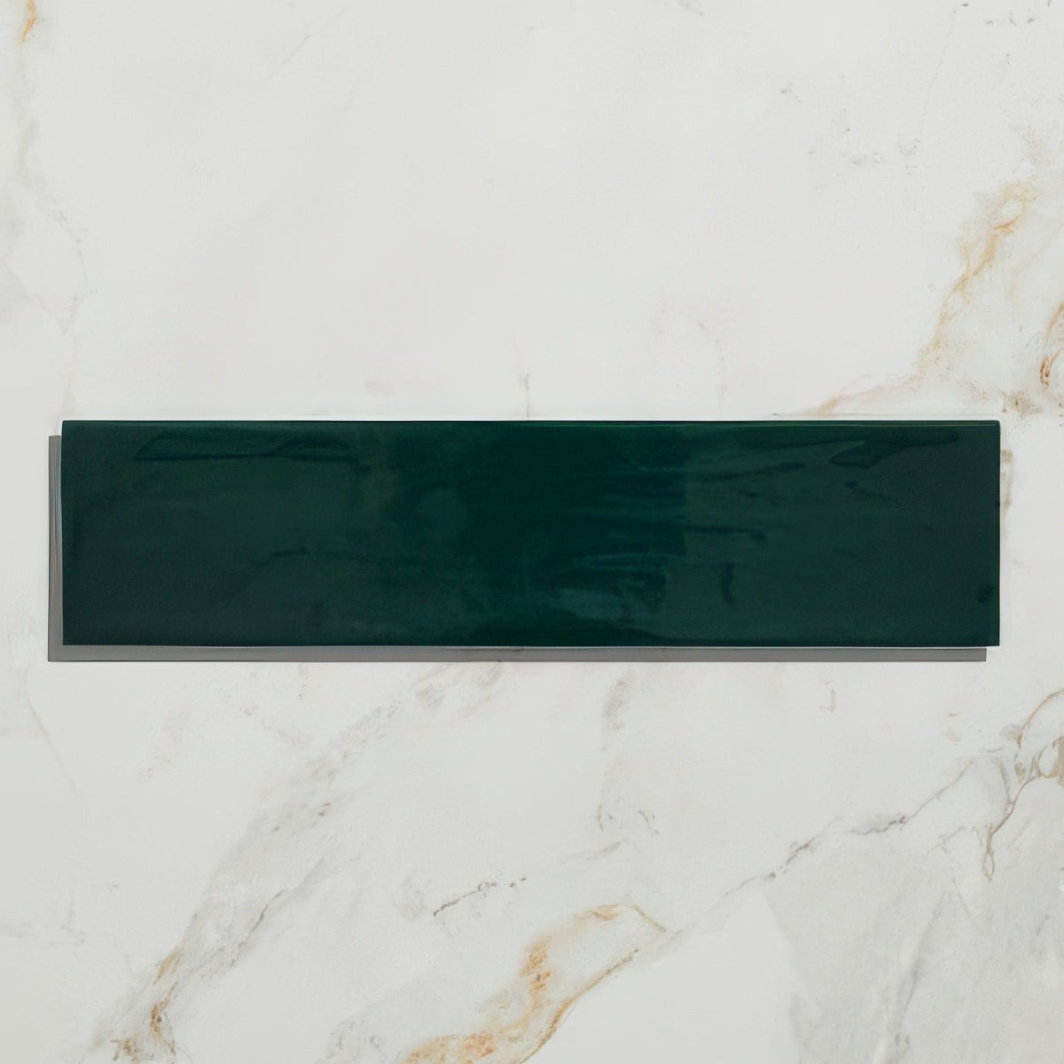 A sleek glossy dark green rectangular kennet porcelain bottle green tile with a smooth reflective surface