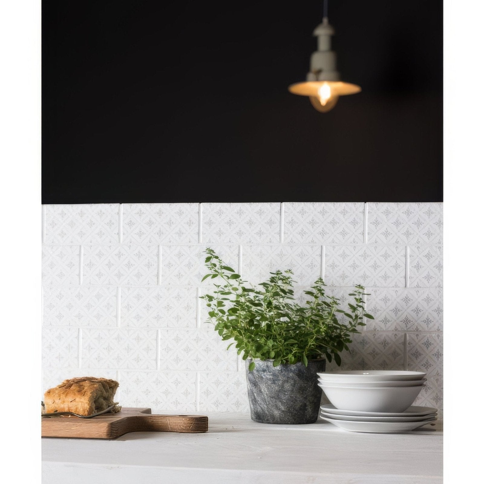 A lush green herb plant in a textured gray stone pot from kew on helmingham collection