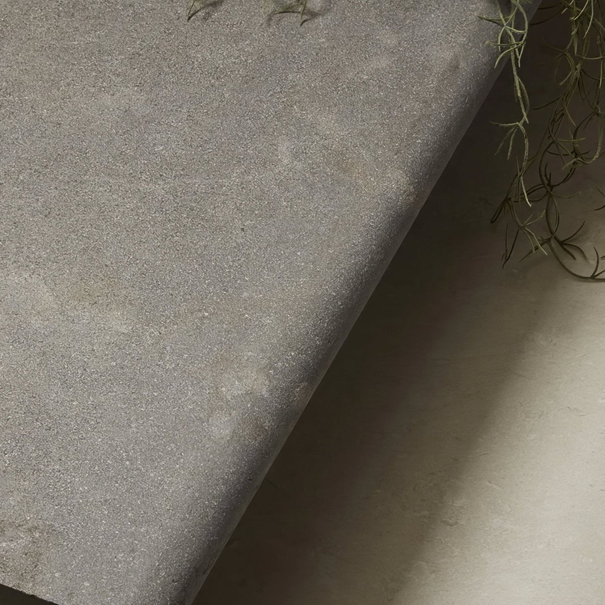 Kimmeridge limestone etched bullnose coping in gray textured fabric with a subtle speckled finish