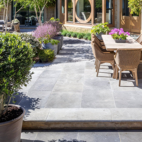 Gray kimmeridge limestone paving tiles with tumbled and etched finish featuring subtle texture and natural veining