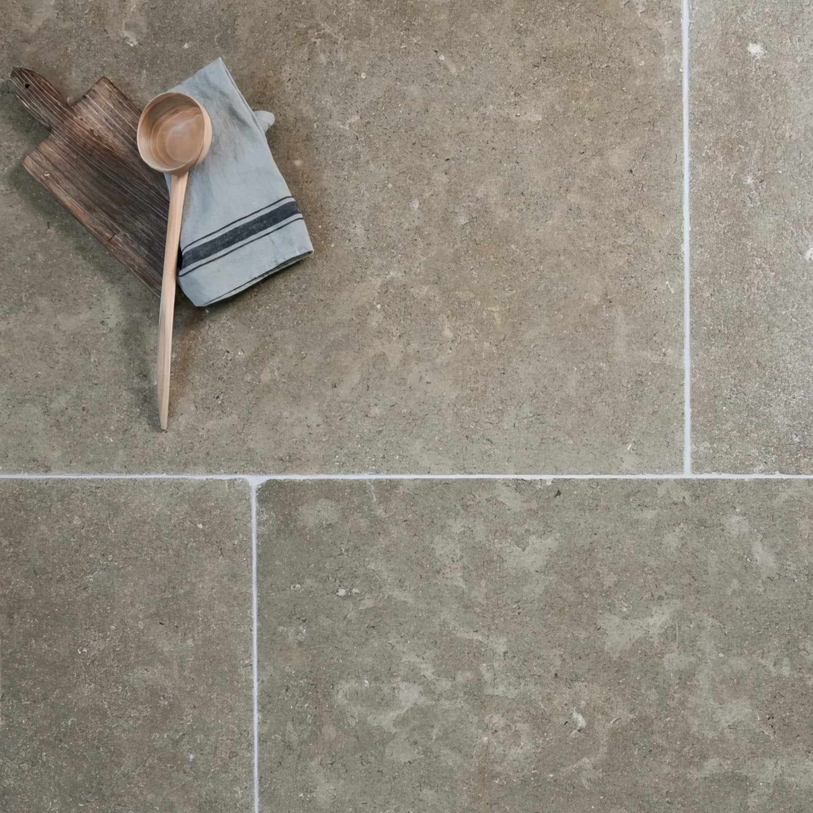 Kimmeridge limestone tumbled and etched gray stone tiles with subtle veining and a matte finish