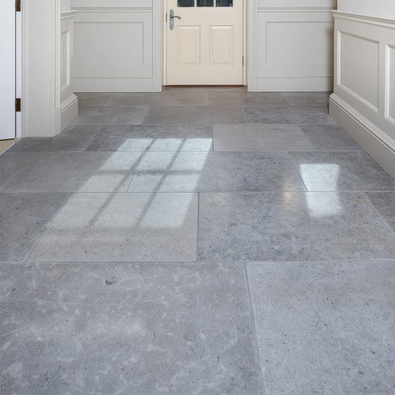 Gray kimmeridge limestone tumbled finish tiles with subtle veining pattern covering the floor