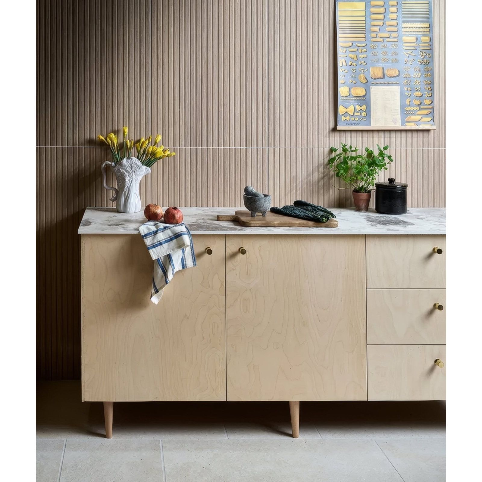 Kinfolk Porcelain Maple light wood-effect porcelain tiles with a wood sideboard and brass handles