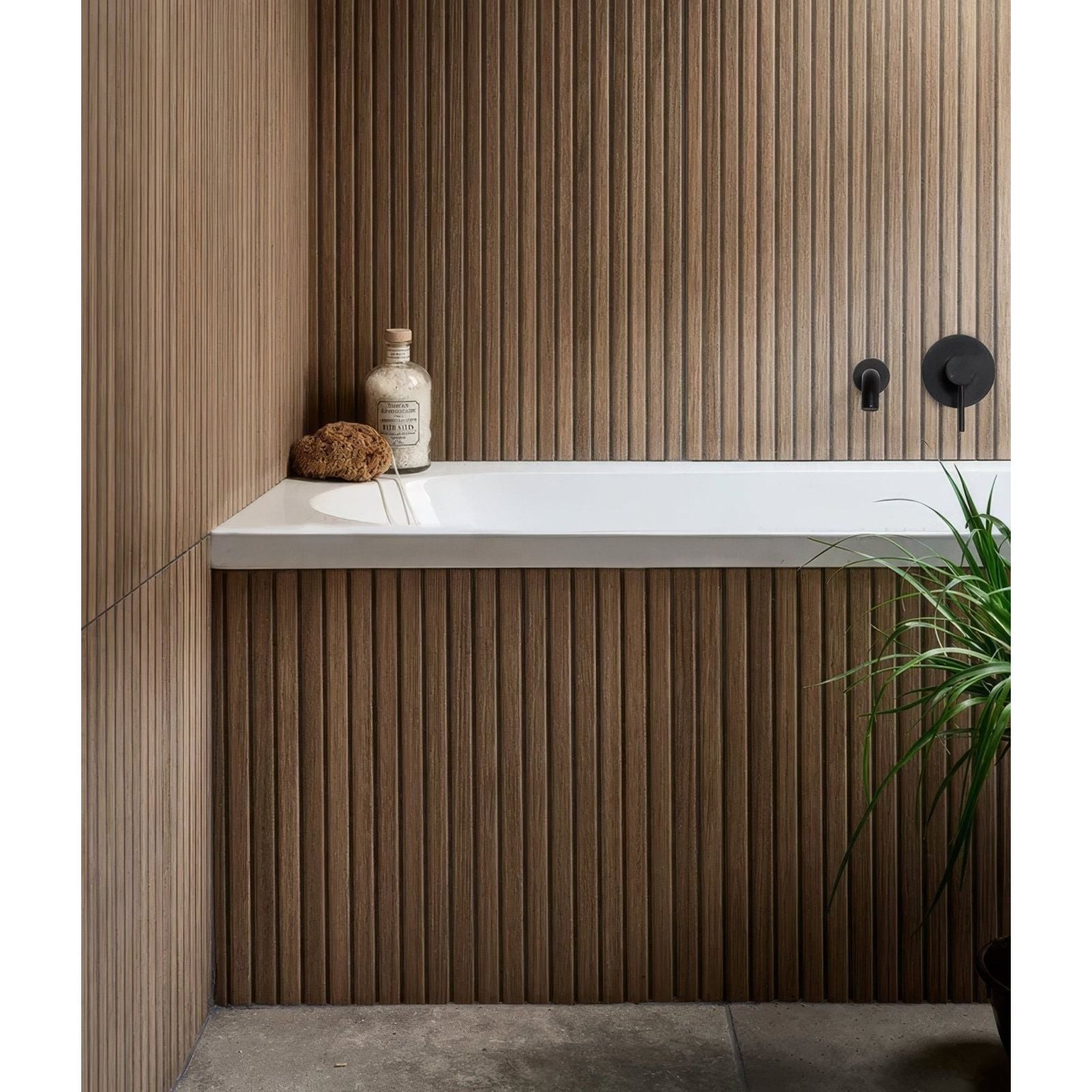 White rectangular Kinfolk porcelain teak bathtub with sleek modern design against vertically grooved wooden paneling