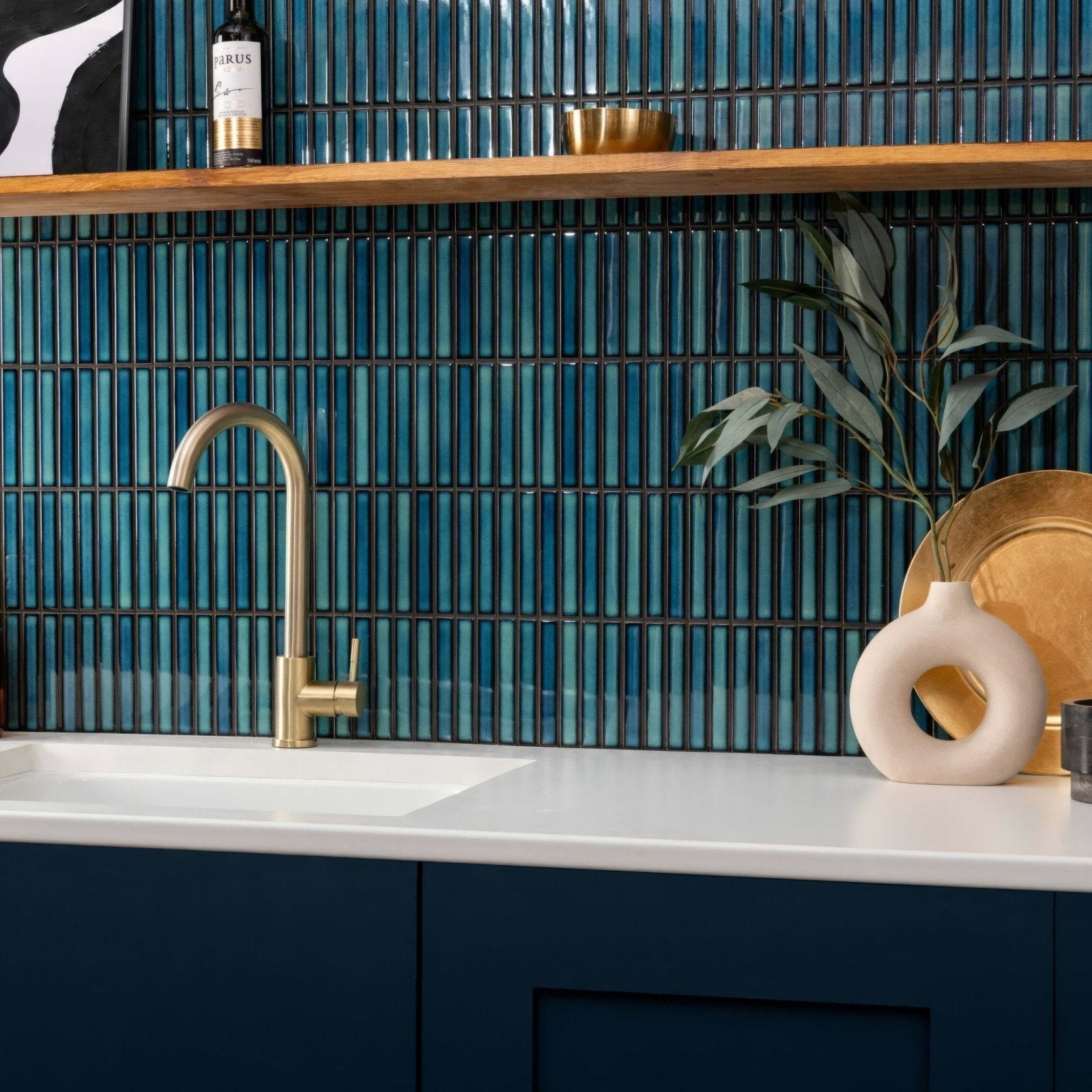 A sleek modern gold faucet with a curved spout and minimalist design for Kitkat Blue Two Tone Mosaic bathroom