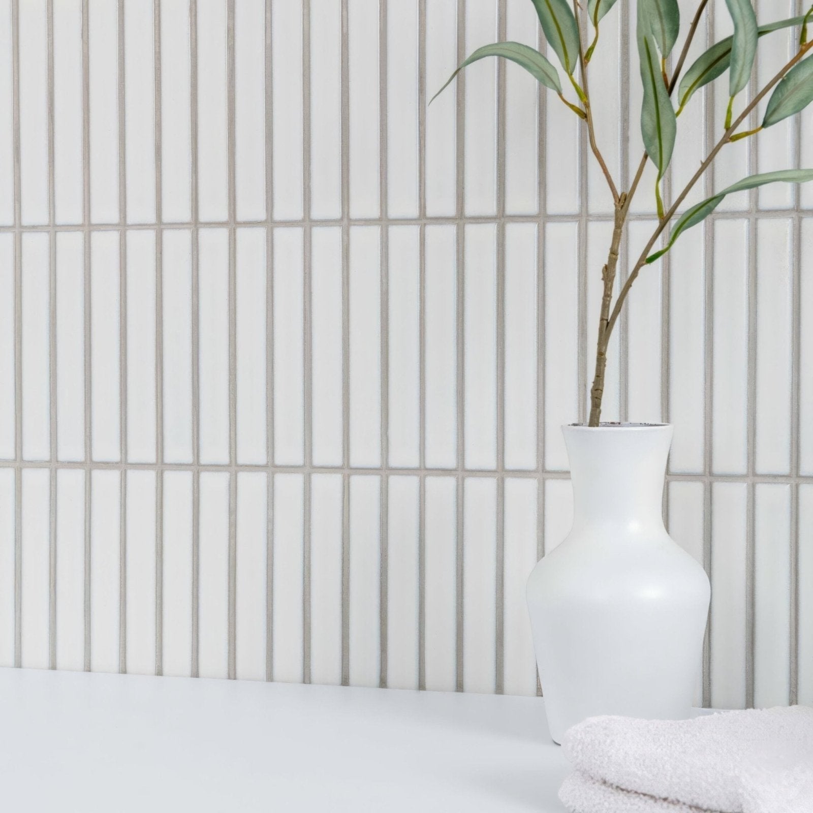 Kitkat White Mosaic white ceramic mosaic with a white vase holding a green branch
