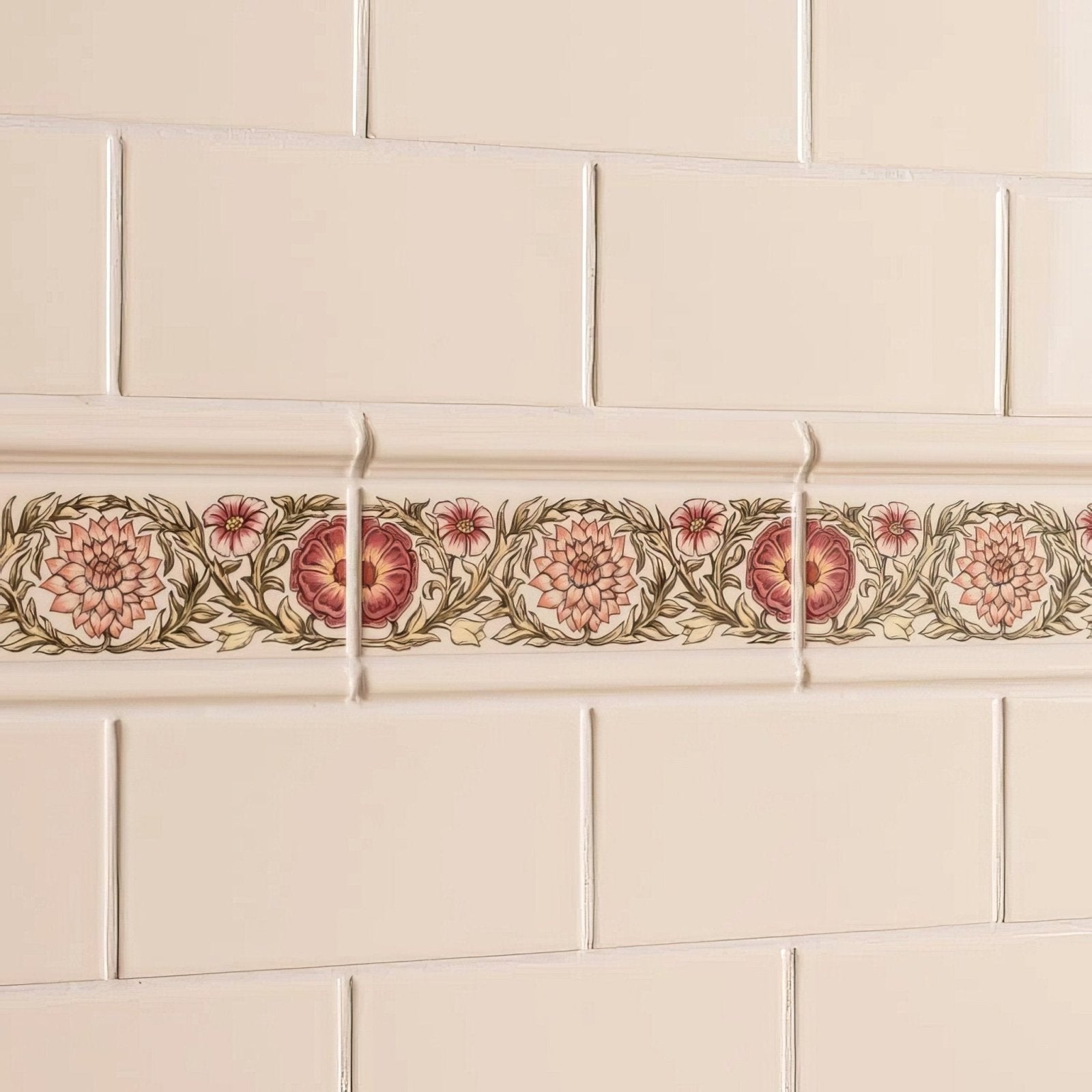 Beige ceramic tile border knot garden with pink floral pattern and green vines on county white background