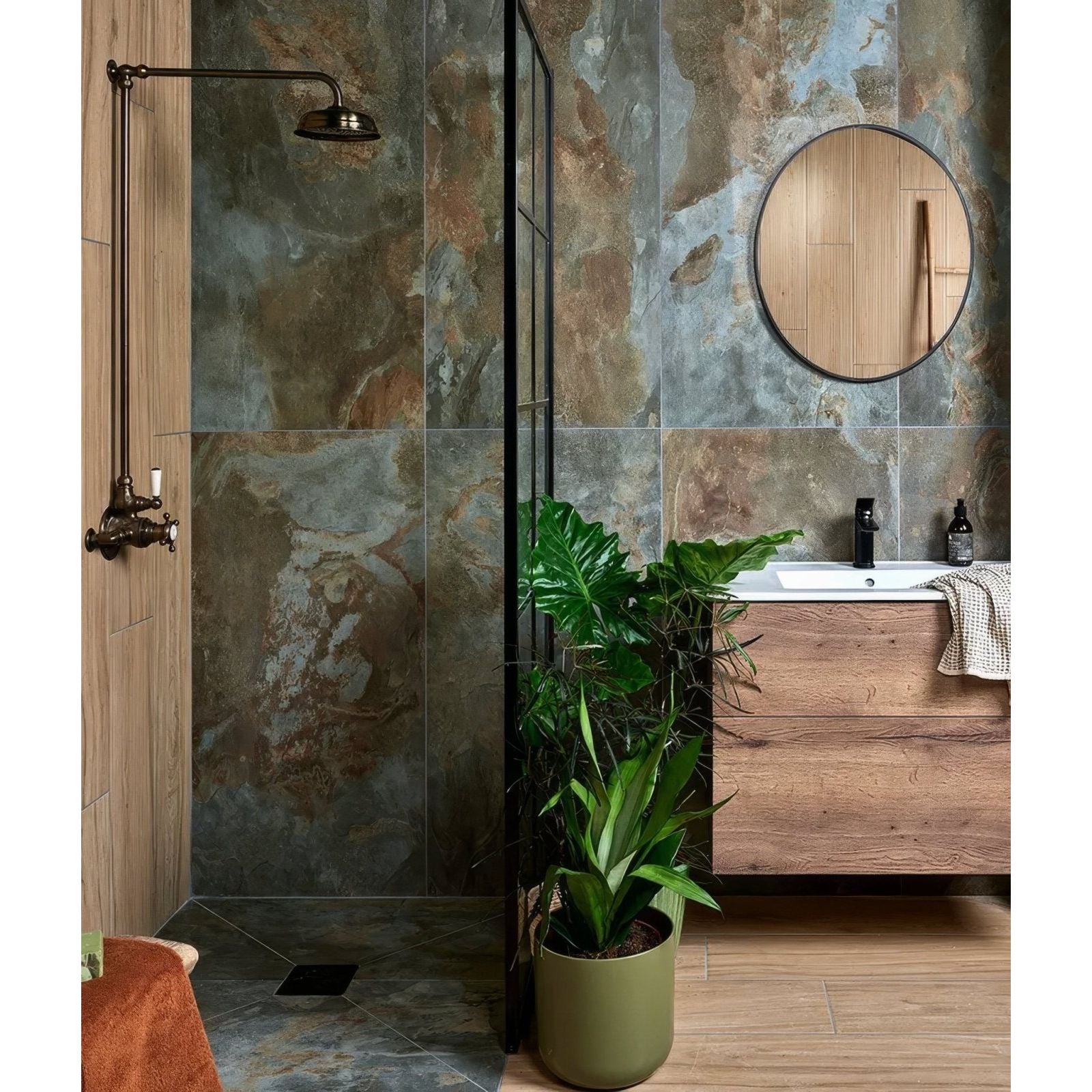 Round wooden-framed mirror with black rim featuring komodo porcelain green detailing for stylish home decor