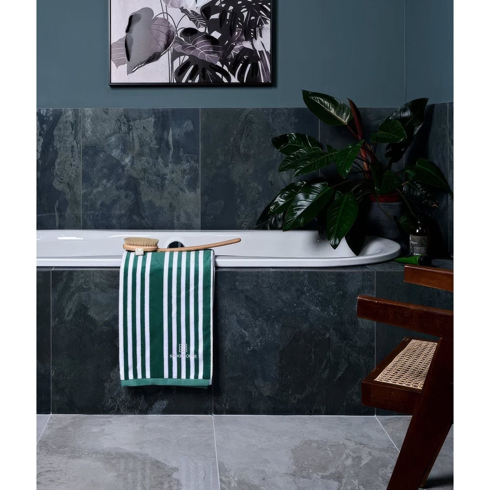 Komodo porcelain ocean green and white striped towel with subtle embroidered logo made of soft cotton