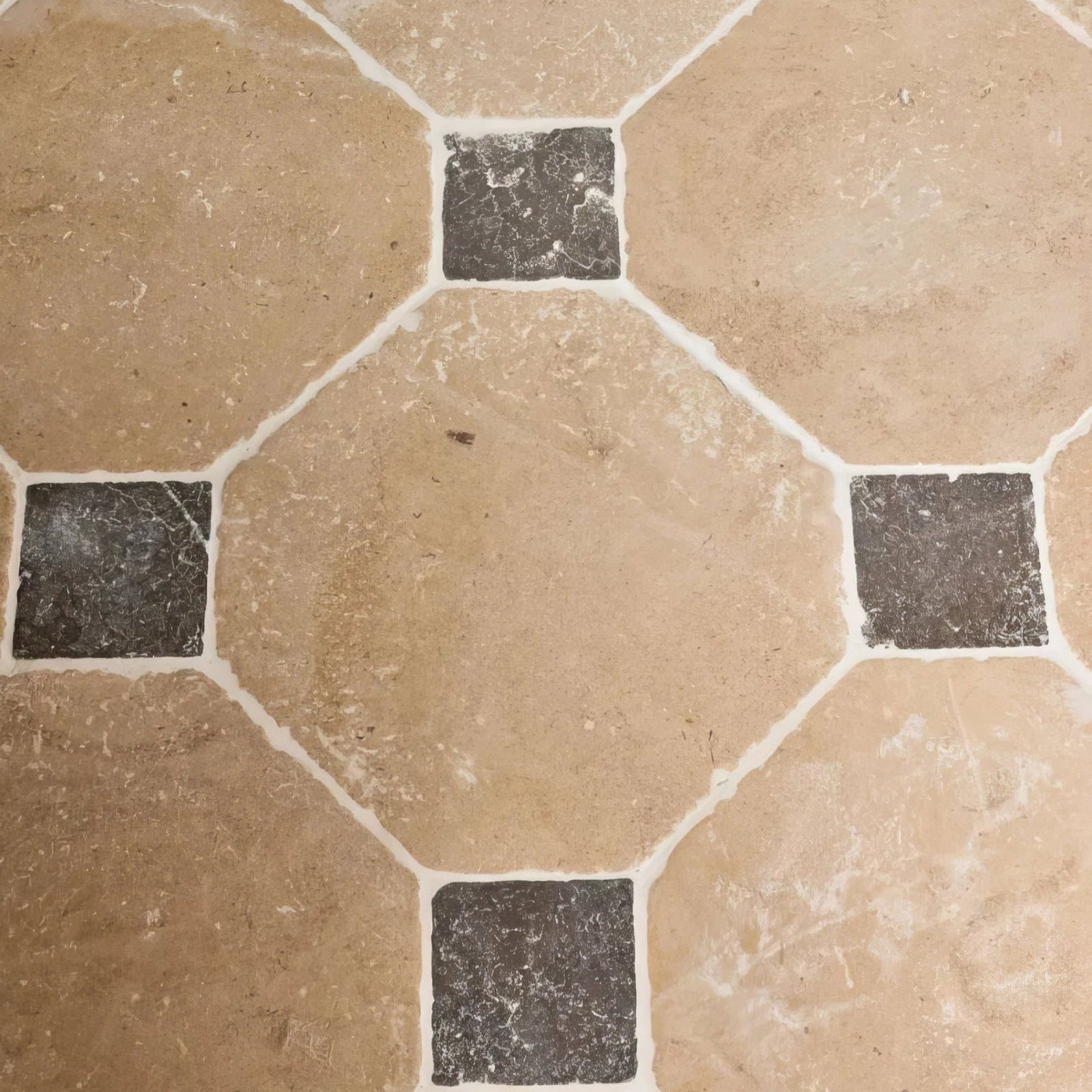 Beige and black octagonal lacock limestone heritage finish stone tiles with white grout forming a geometric pattern