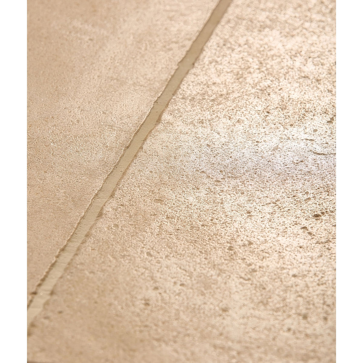 Beige lacock limestone tumbled finish tile with textured surface subtle speckles and visible grout line