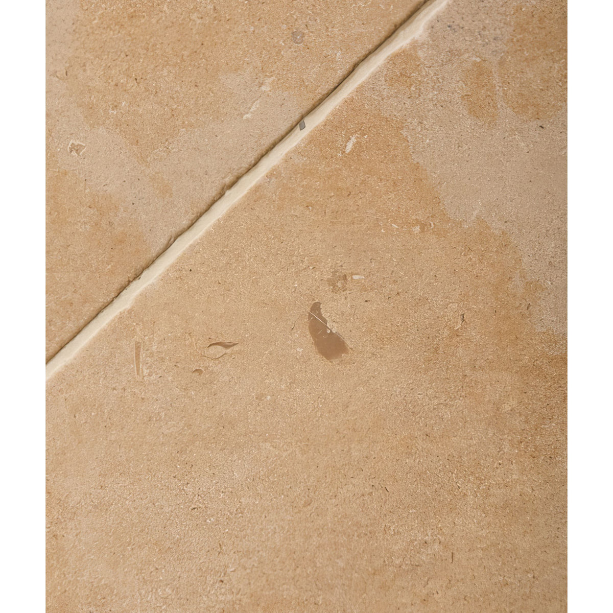Lacock Limestone Tumbled Finish beige limestone tile with a tumbled finish and subtle textured surface showing a visible grout line