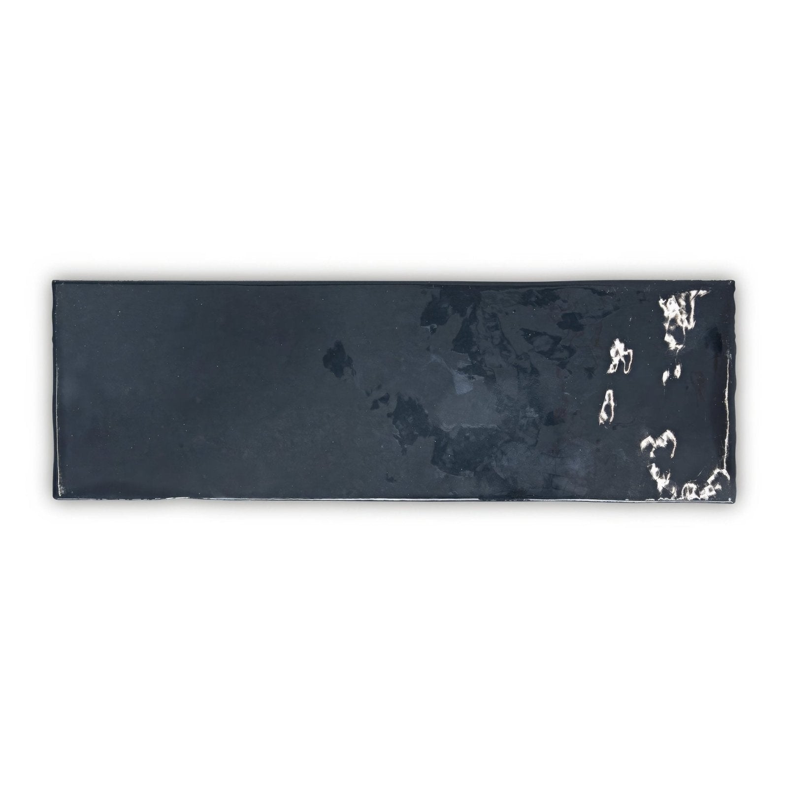 A sleek glossy black landscape dusk navy blue tile with a subtle white abstract pattern on its surface