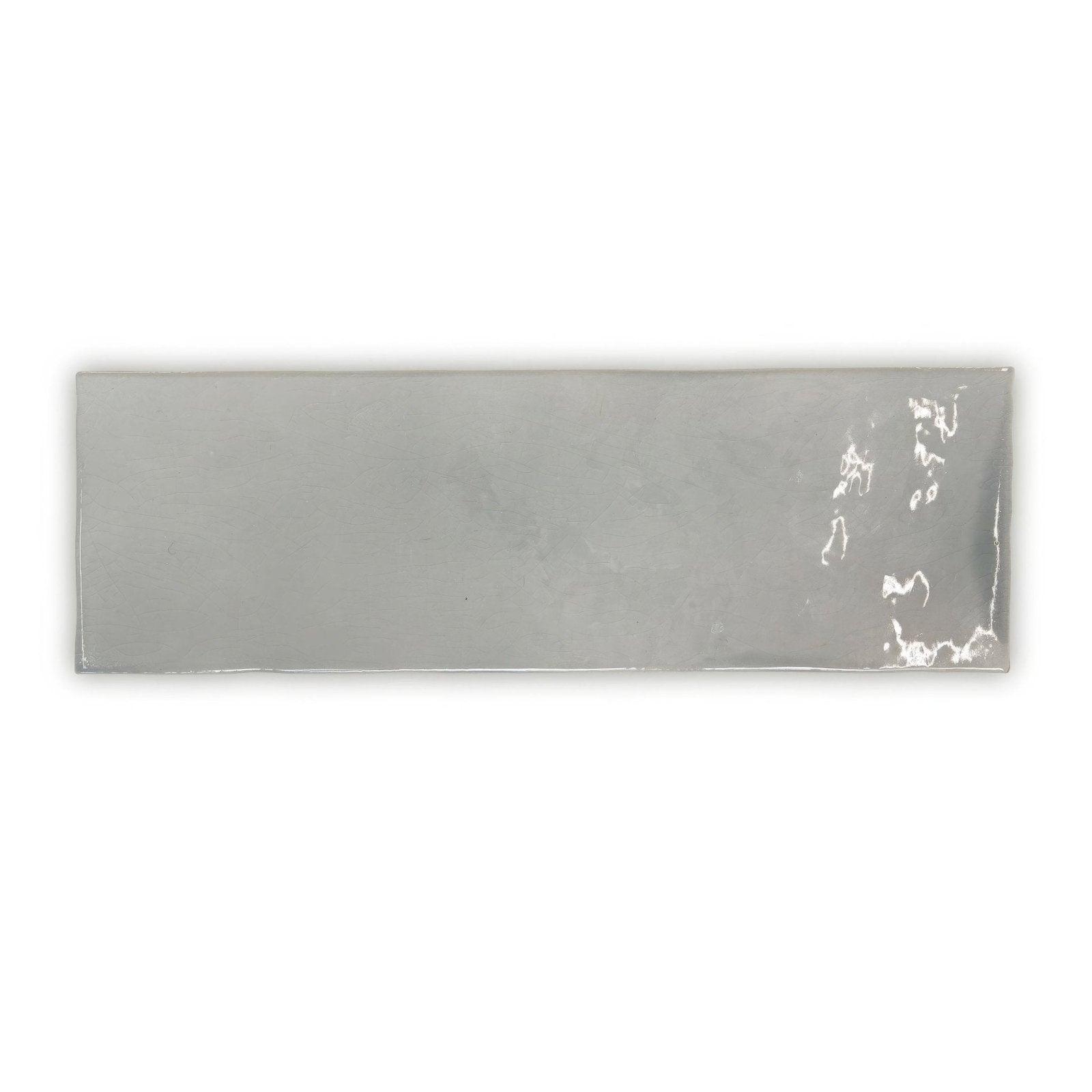 A sleek rectangular silver metallic landscape haze grey tile with subtle sheen and minor surface imperfections