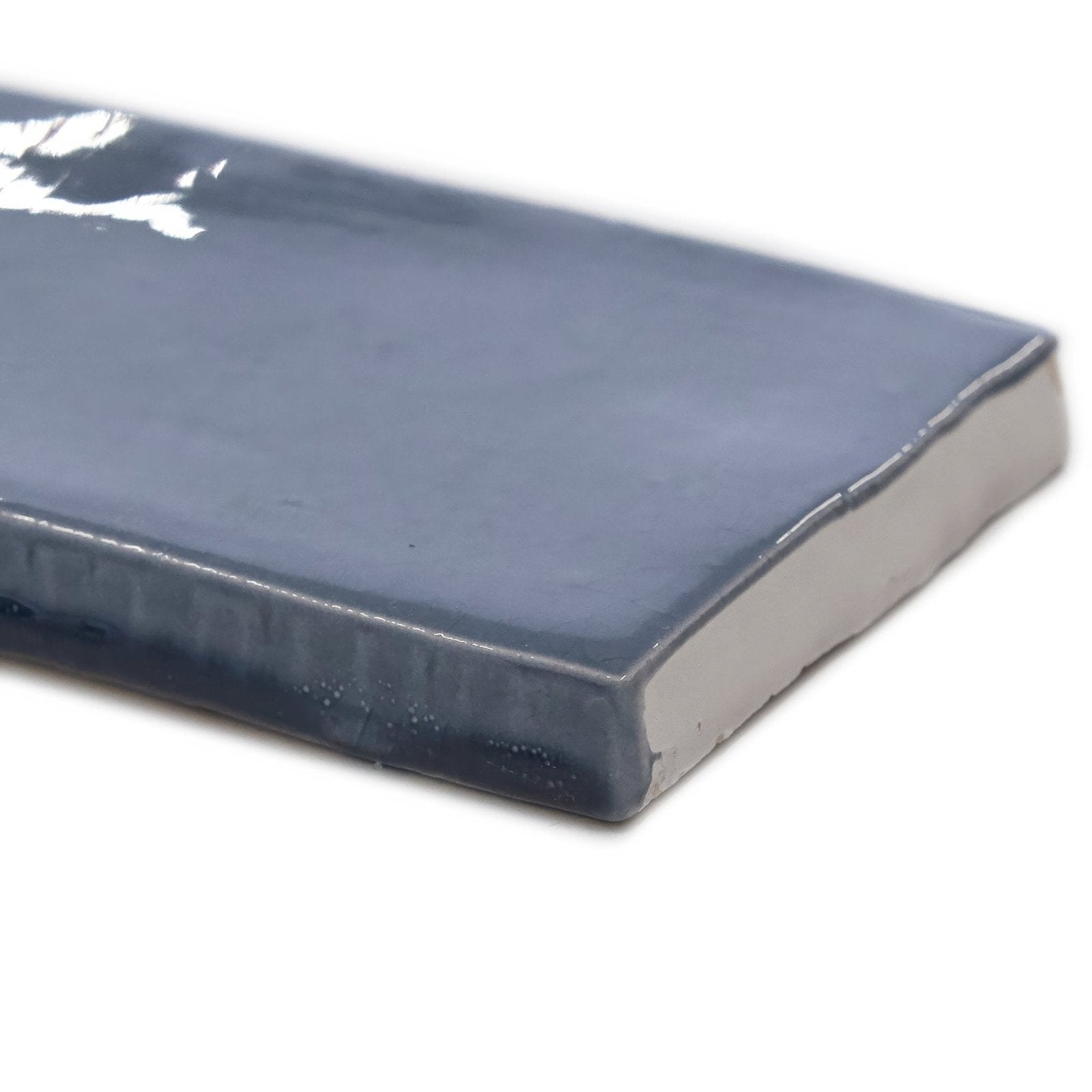 A sleek rectangular ceramic landscape mist blue tile with a glossy dark gray glaze and subtly textured edges
