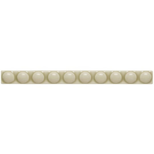 Cream-colored ceramic tile lavenham empire with a row of evenly spaced glossy spherical beads embedded along its length