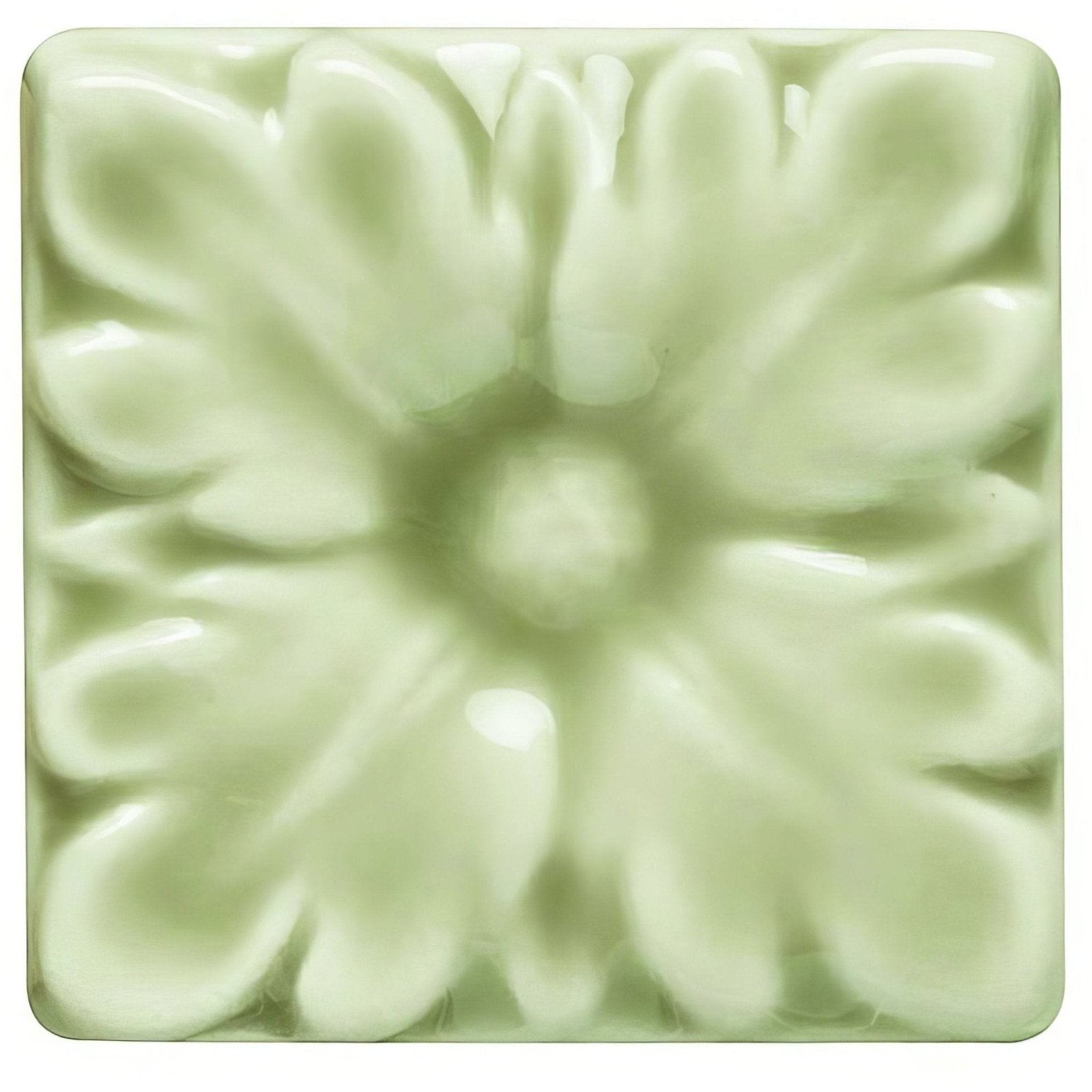 A pale green ceramic tile with raised floral design from the lavenham knightsbridge collection