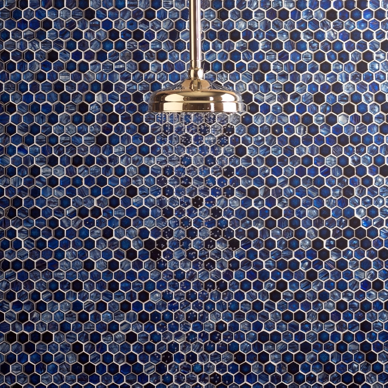 Lazuli Glass and Ceramic Hexagon Mosaic blue hexagon mosaic with a gold showerhead