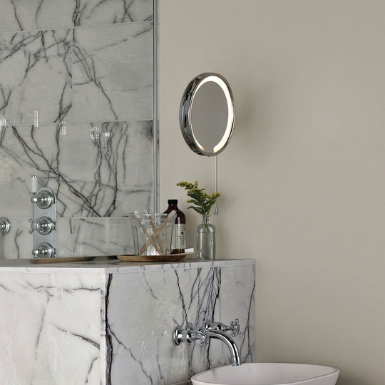 Circular lime white vanity mirror with sleek chrome frame and integrated led lighting for enhanced visibility