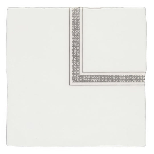 A crisp white silk pocket square with a silver geometric pattern on folded edges from linen corner grey on cotton