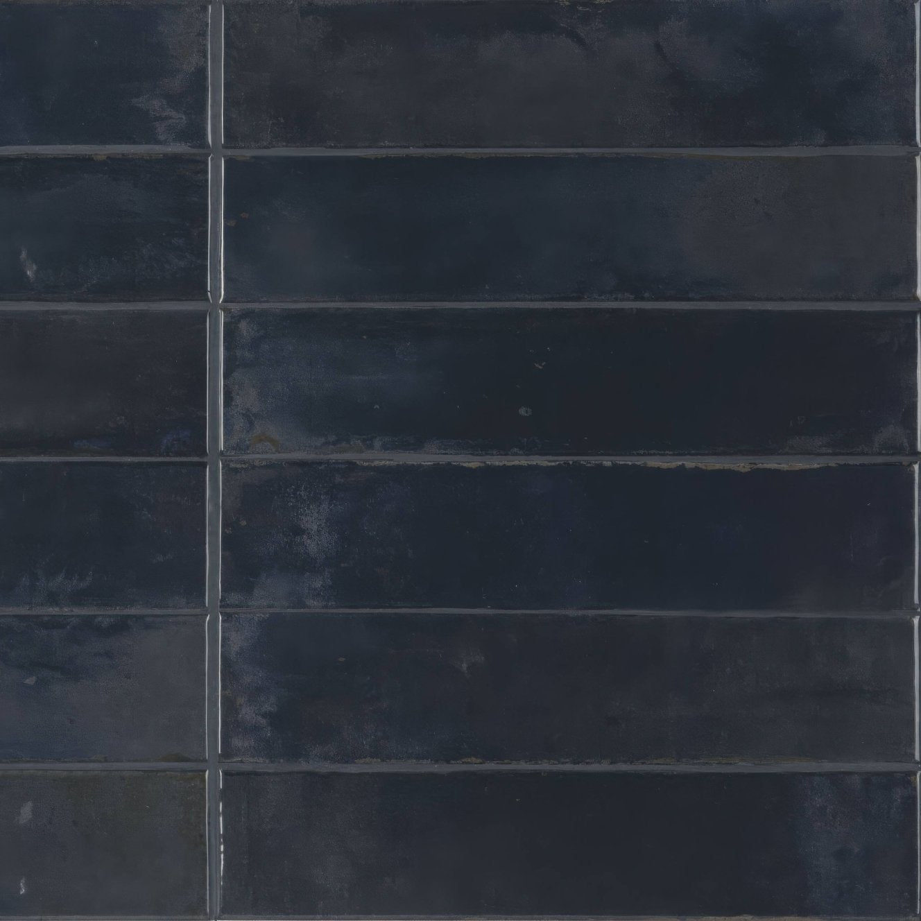 Dark blue rectangular ceramic tiles with a matte textured finish arranged in a grid pattern from lisbon blue cobalt shine collection