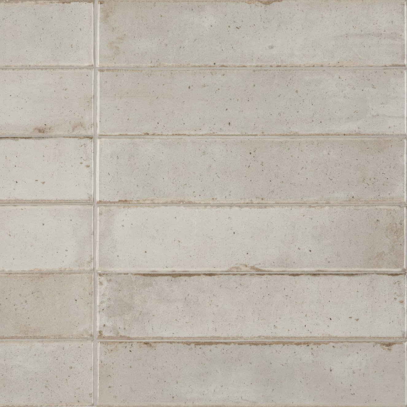 Beige rectangular ceramic tiles with subtle speckled texture and faintly weathered edges in Lisbon oyster shine finish