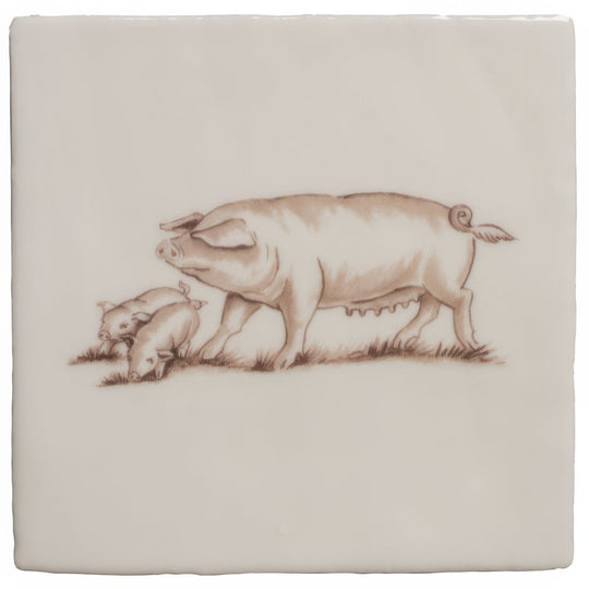 Cream-colored ceramic tile with a delicate brown sepia illustration of an adult pig and two piglets grazing on cotton
