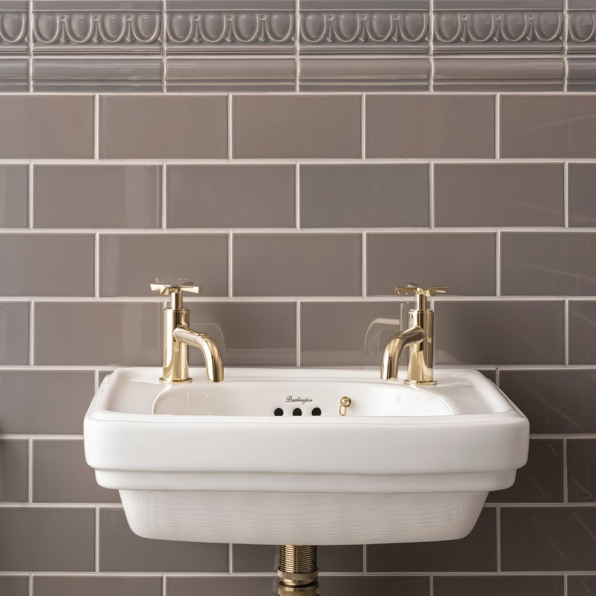 White ceramic wall-mounted sink with gold-finished faucets from london stone albert moulding collection