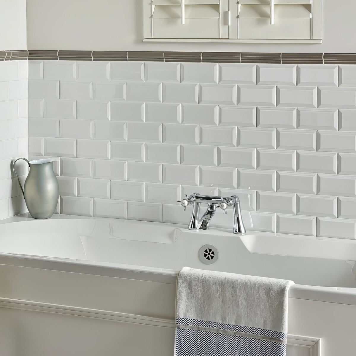 White subway tile backsplash with subtle raised texture and uniform rectangular pattern from london stone albert moulding