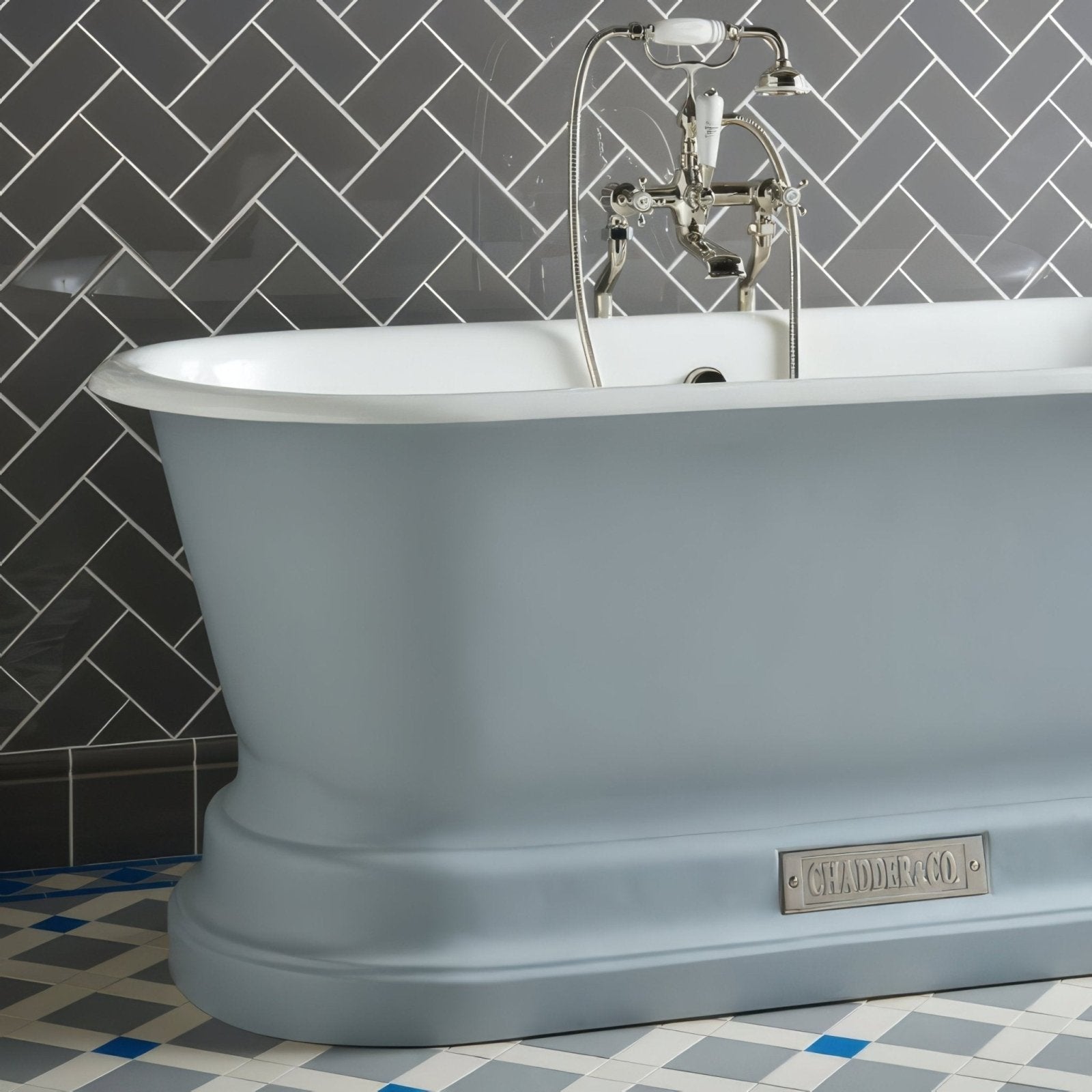 A sleek matte-finish light blue freestanding bathtub with curved design and polished chrome faucet in London Stone Half Tile