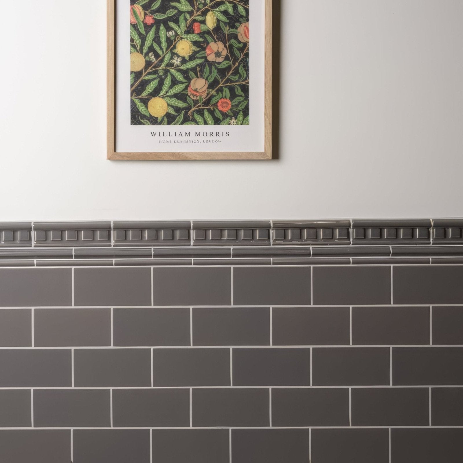 Dark gray rectangular london stone half tile subway tiles with white grout form a clean modern wall surface