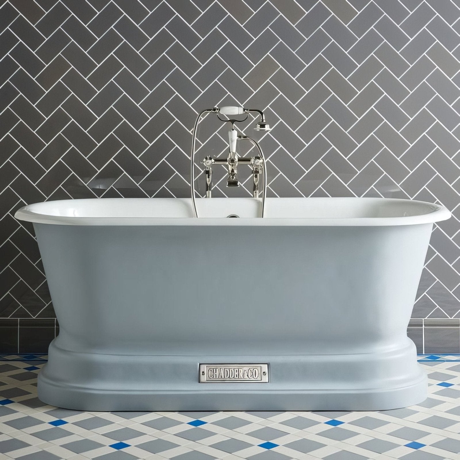A light blue freestanding bathtub with classic design and chrome fixtures shown with london stone skirting tile
