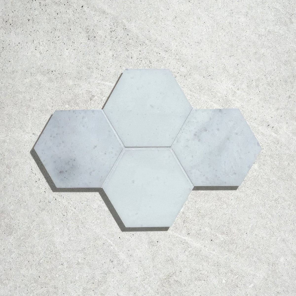 Long island marble large hexagon mosaic featuring light gray hexagonal marble tiles arranged in a star-like pattern