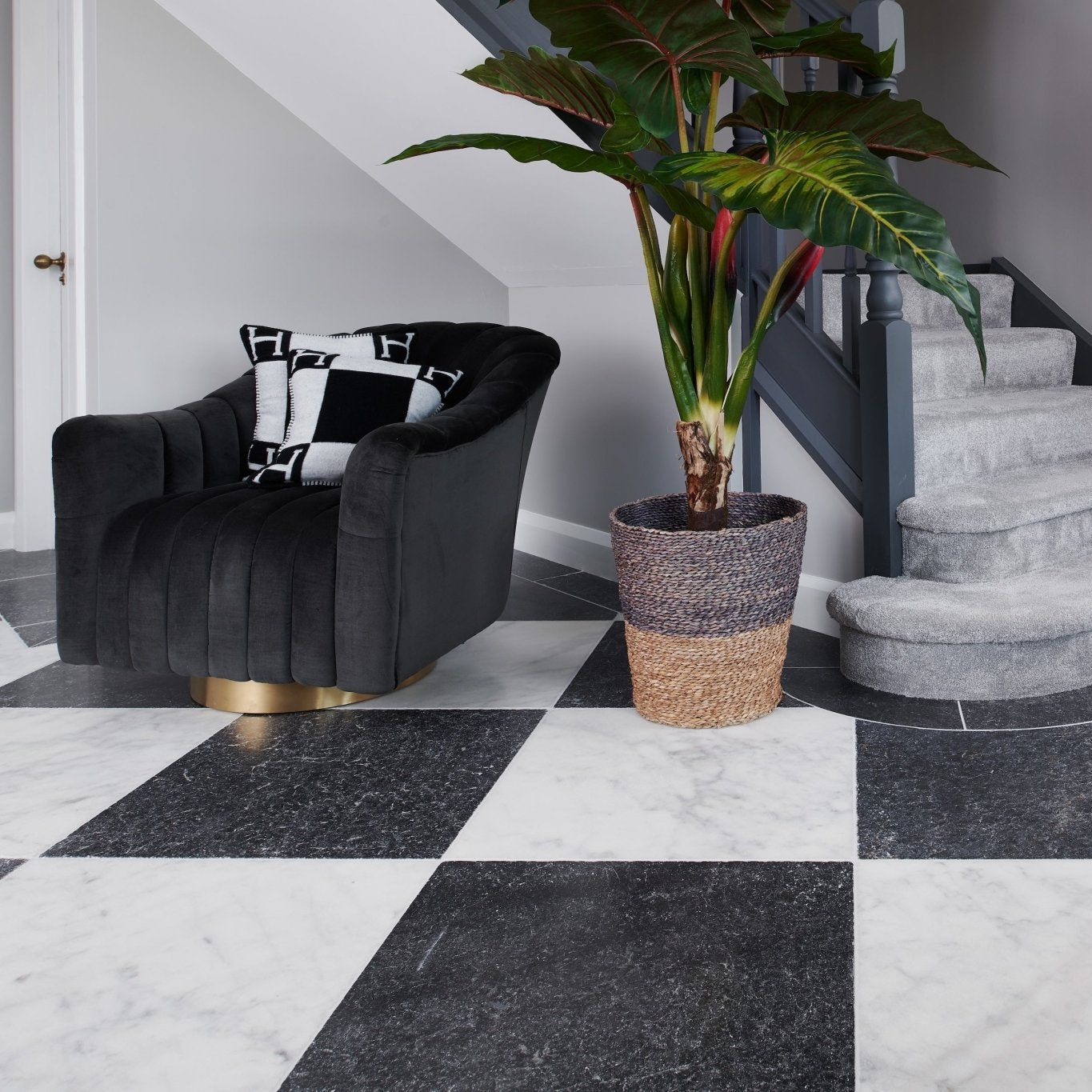 Long Island Marble Tumbled Finish 40.6 x 40.6cm black and white marble tiles with a black velvet armchair