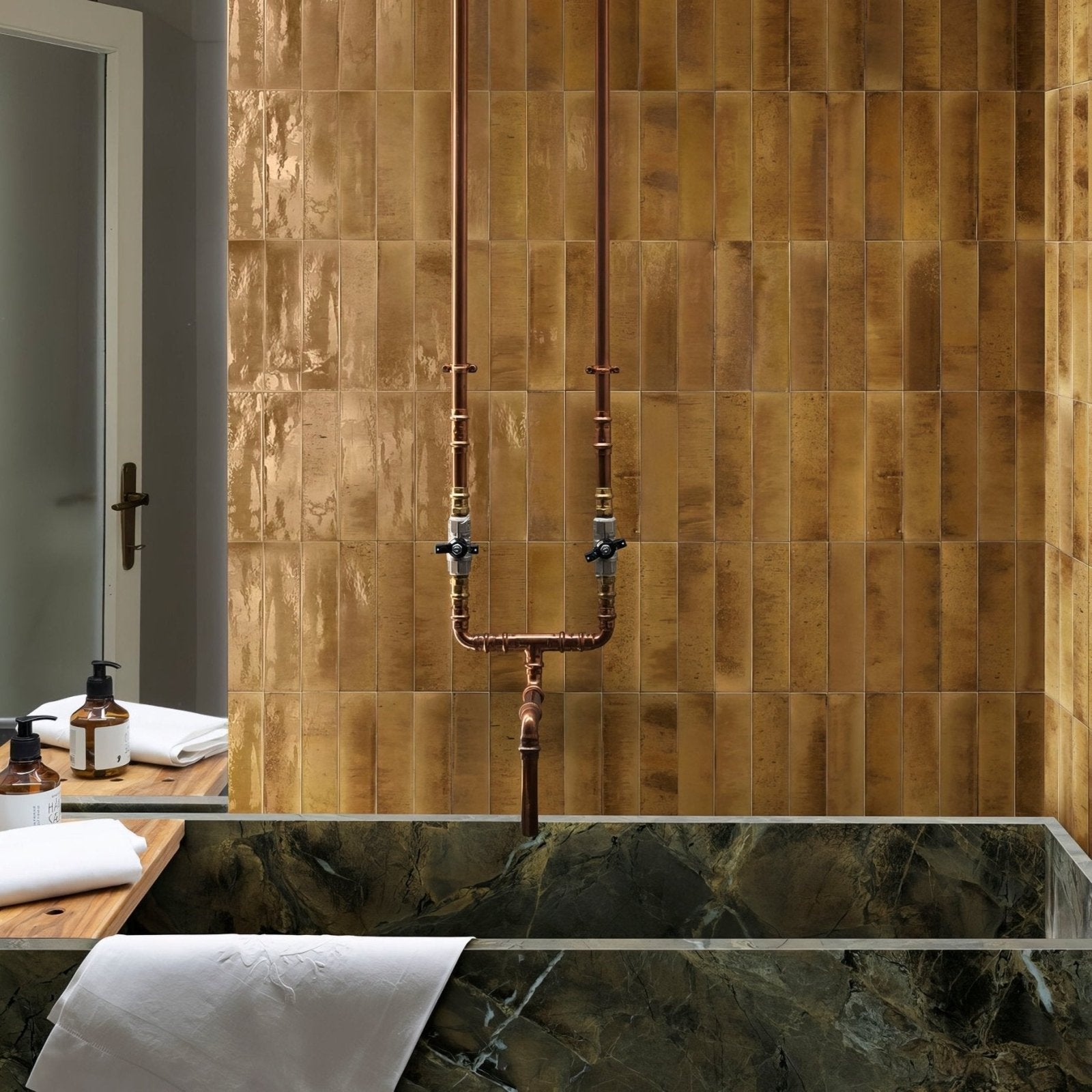 Copper pipe shower fixture with brass fittings against golden textured tiles in luminous lume beige design