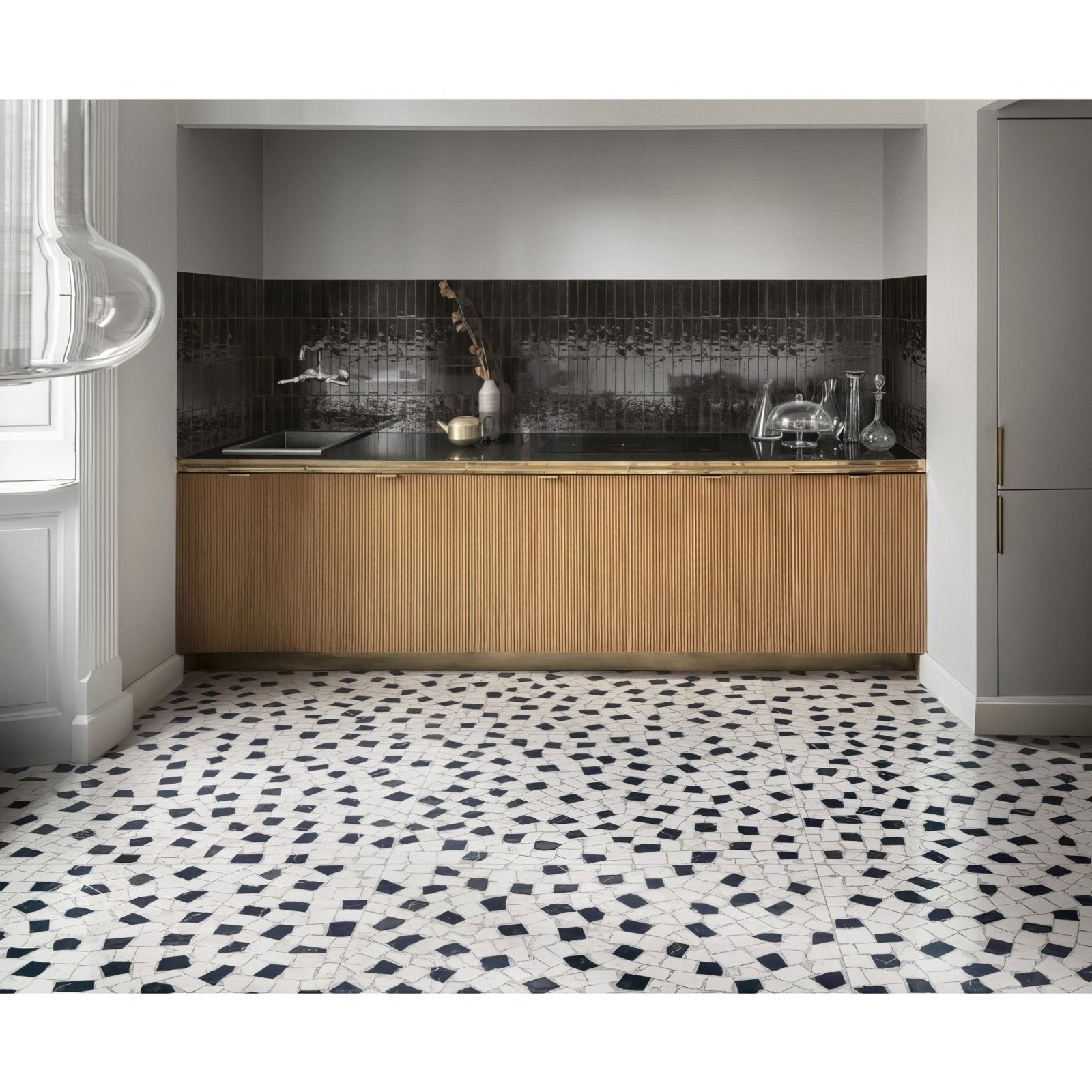 Black and white mosaic tile floor with irregular geometric patterns from luminous lume black collection
