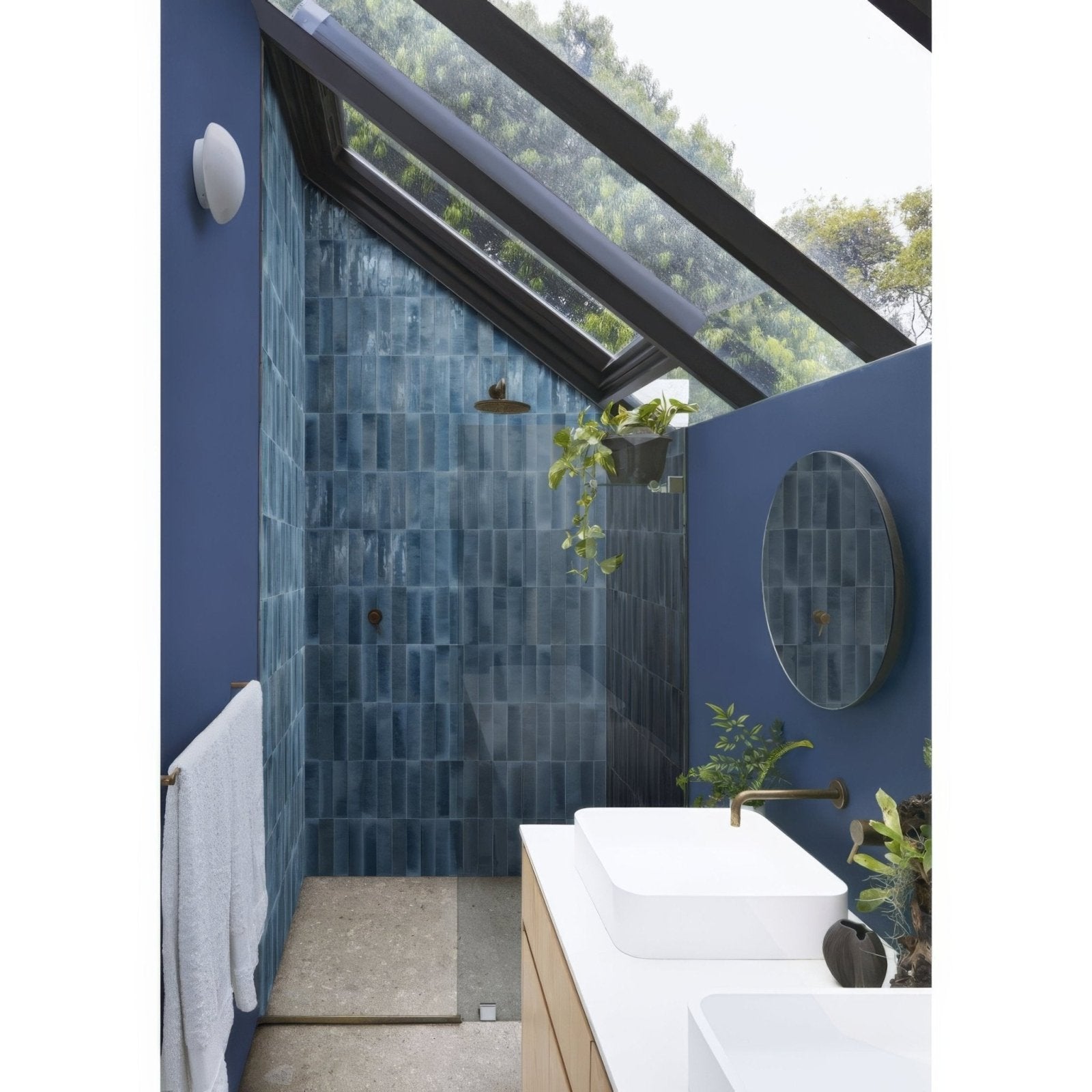 Blue rectangular ceramic tiles with a glossy finish lining shower walls from luminous lume blu china collection