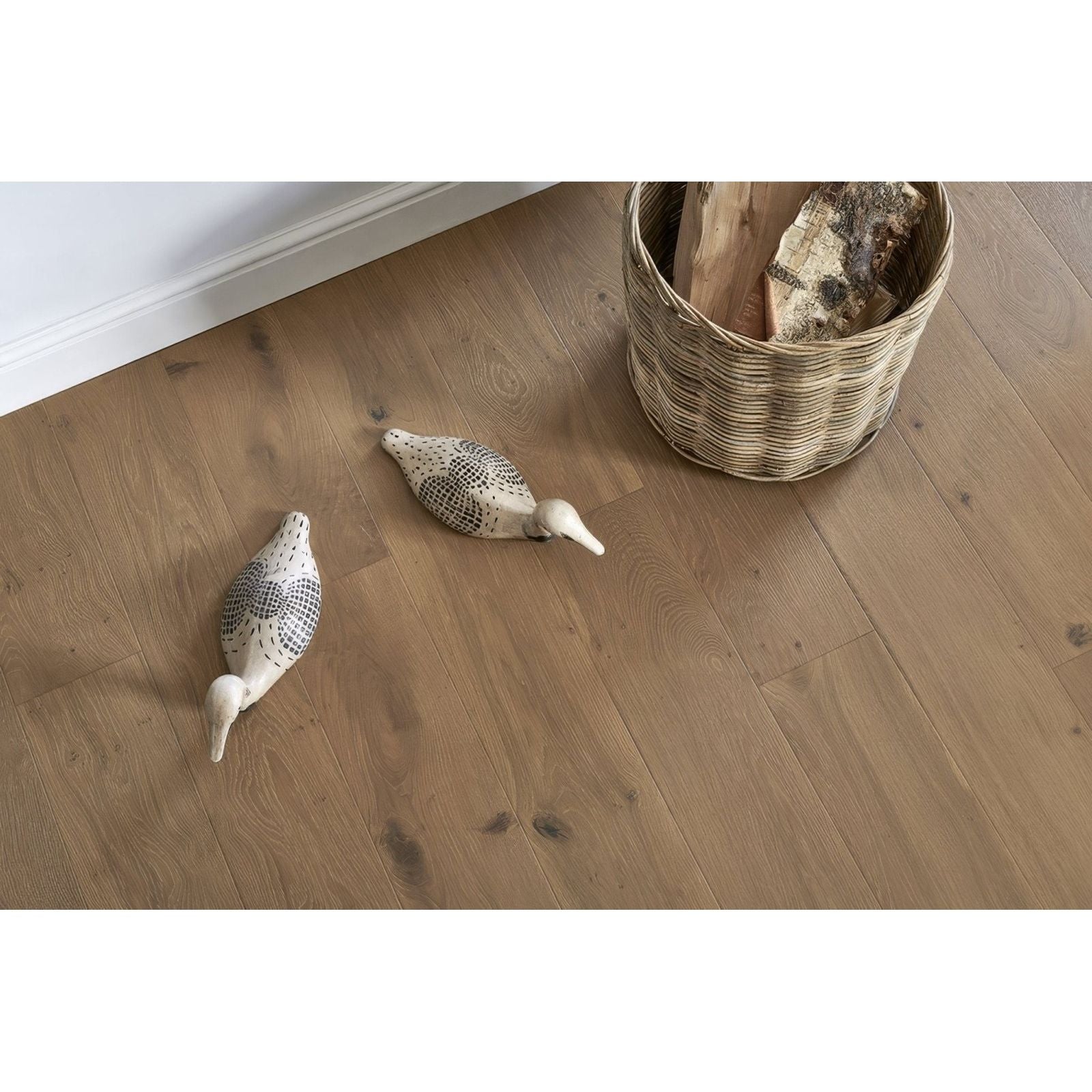 Two white ceramic ducks with black dotted patterns side by side on light wood floor in lynton chiffon oak style
