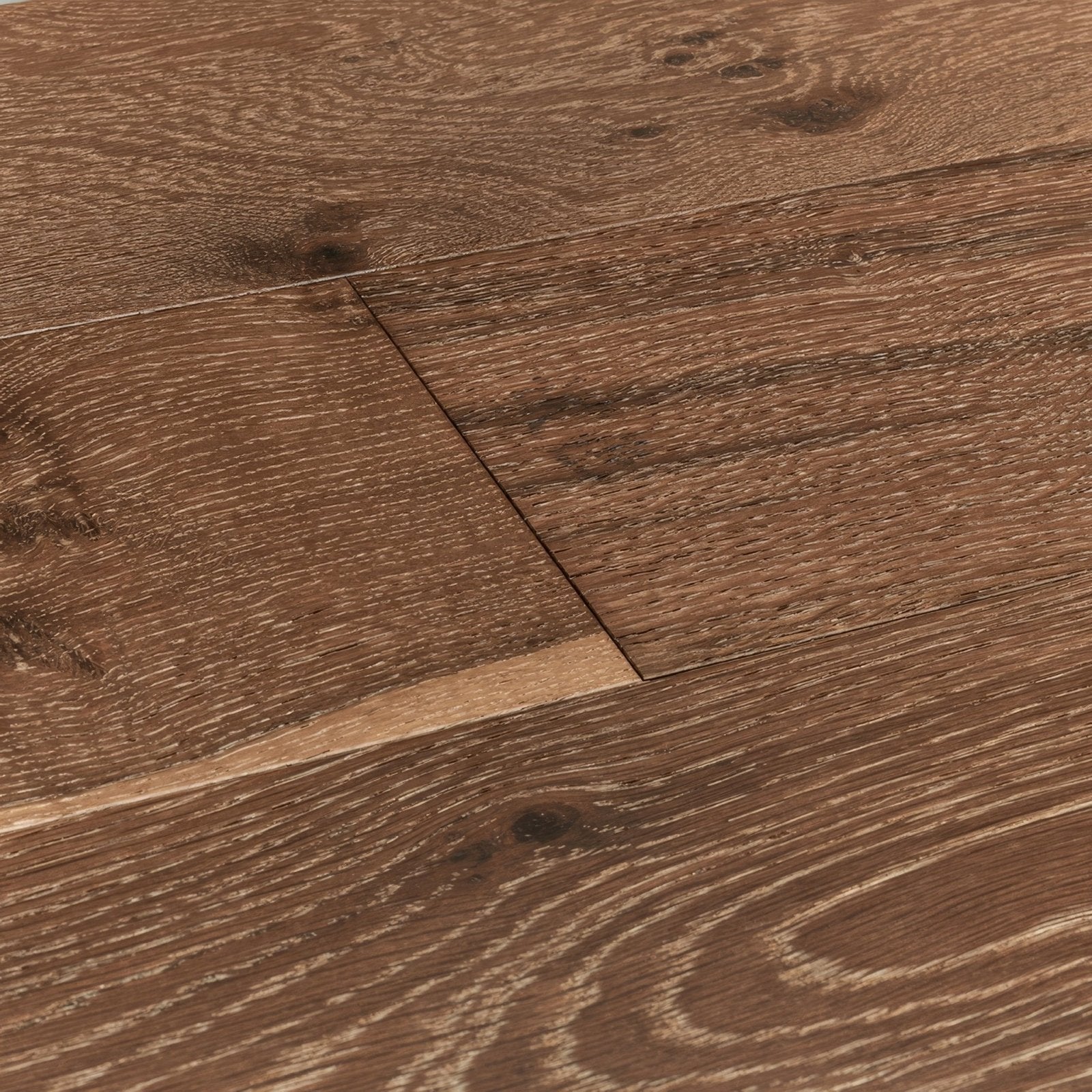 Dark brown hardwood floor planks of lynton evening oak with natural wood grain pattern and visible knots
