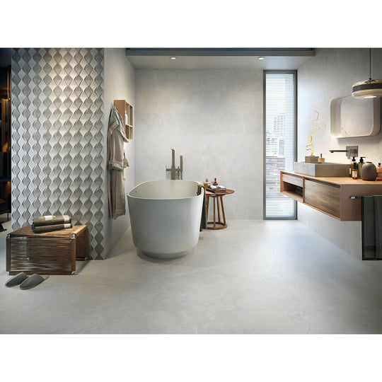 Lyon 1836 Perla Matt light grey marble-effect tiles with a freestanding bathtub