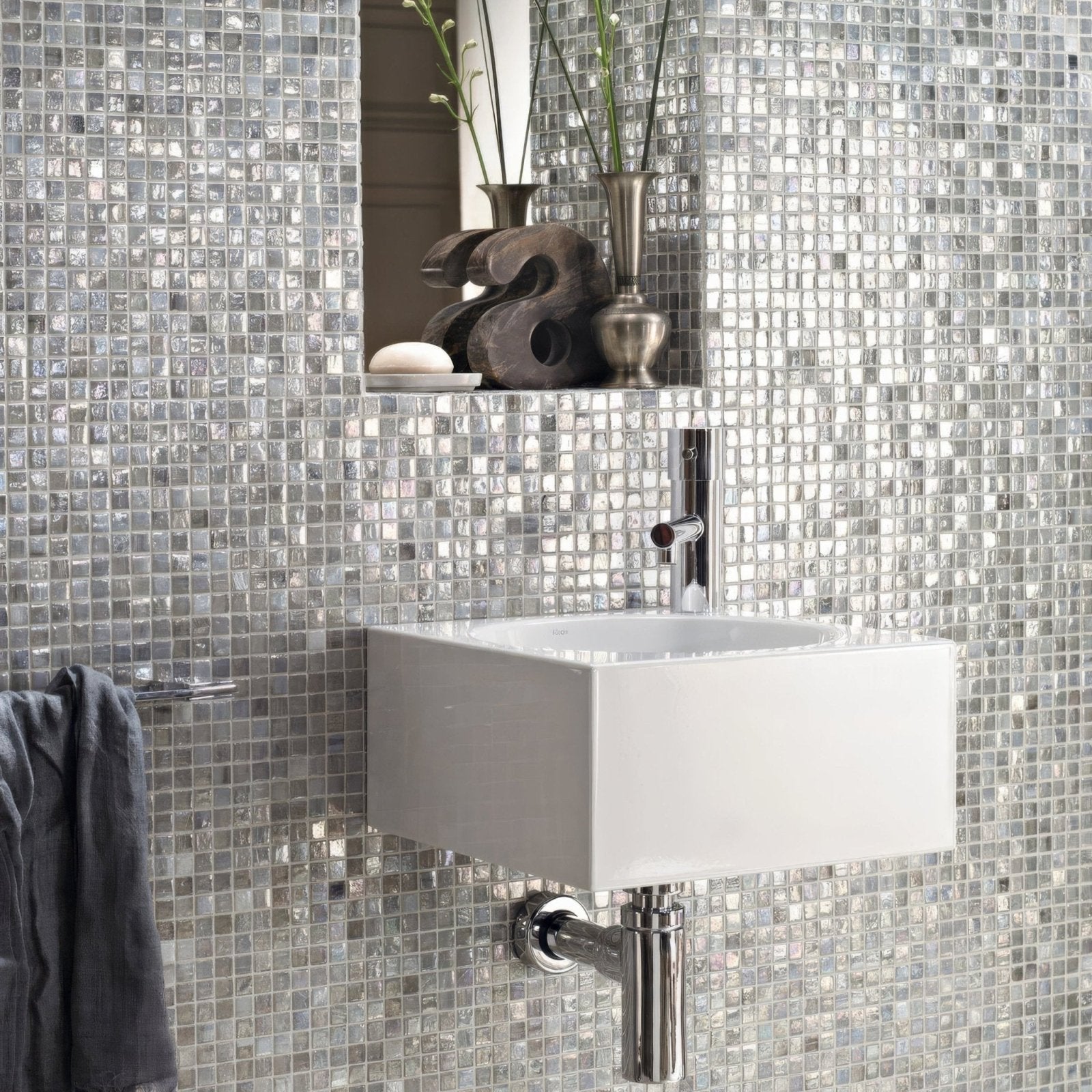 White rectangular wall-mounted ceramic sink with chrome faucet and exposed plumbing from malacassa glacier square mosaic