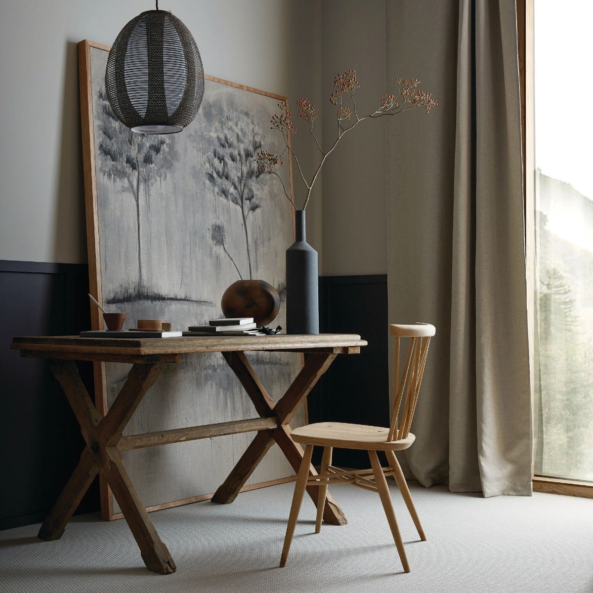 Rustic wooden malm table with distinctive x-shaped base and natural wood grain finish for dining or workspace use