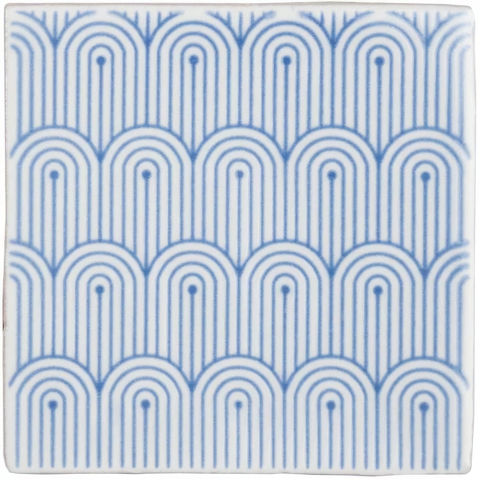 Blue and white ceramic tile manoir deco on papyrus featuring a repeating geometric pattern of arched lines